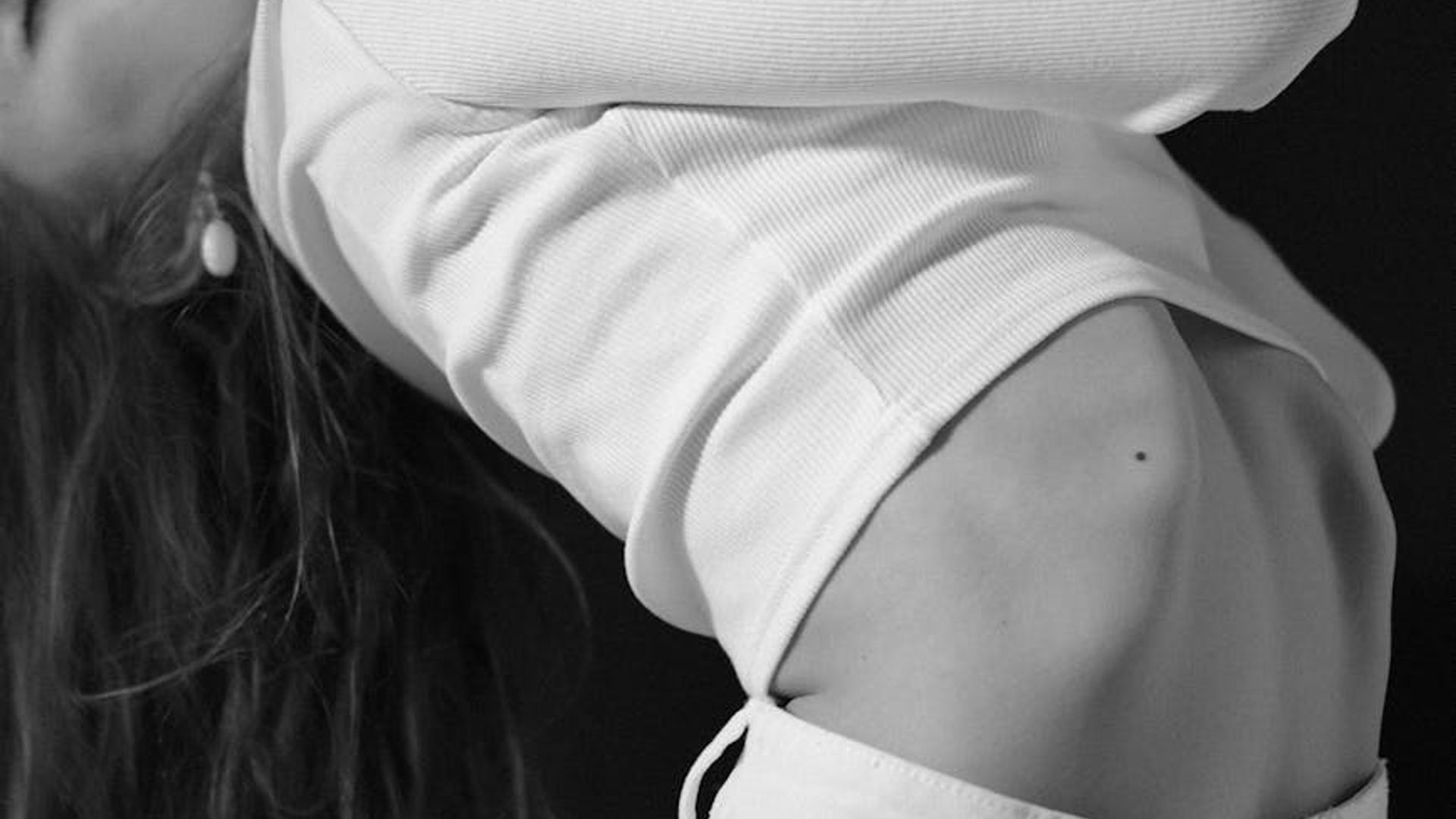 Silhouette of a person in a dynamic stretching pose at dawn.